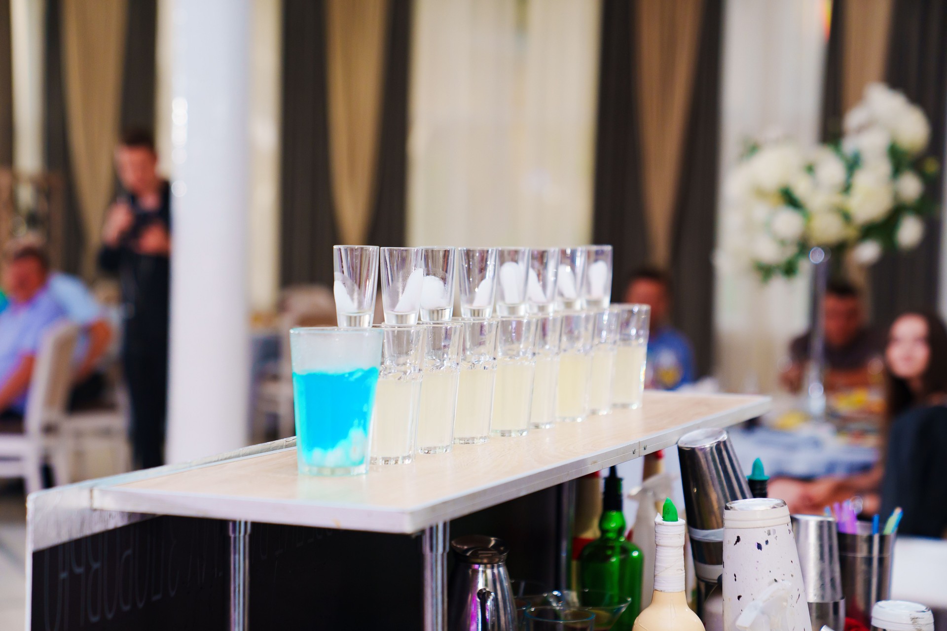 Bar counter with shots of different drinks.