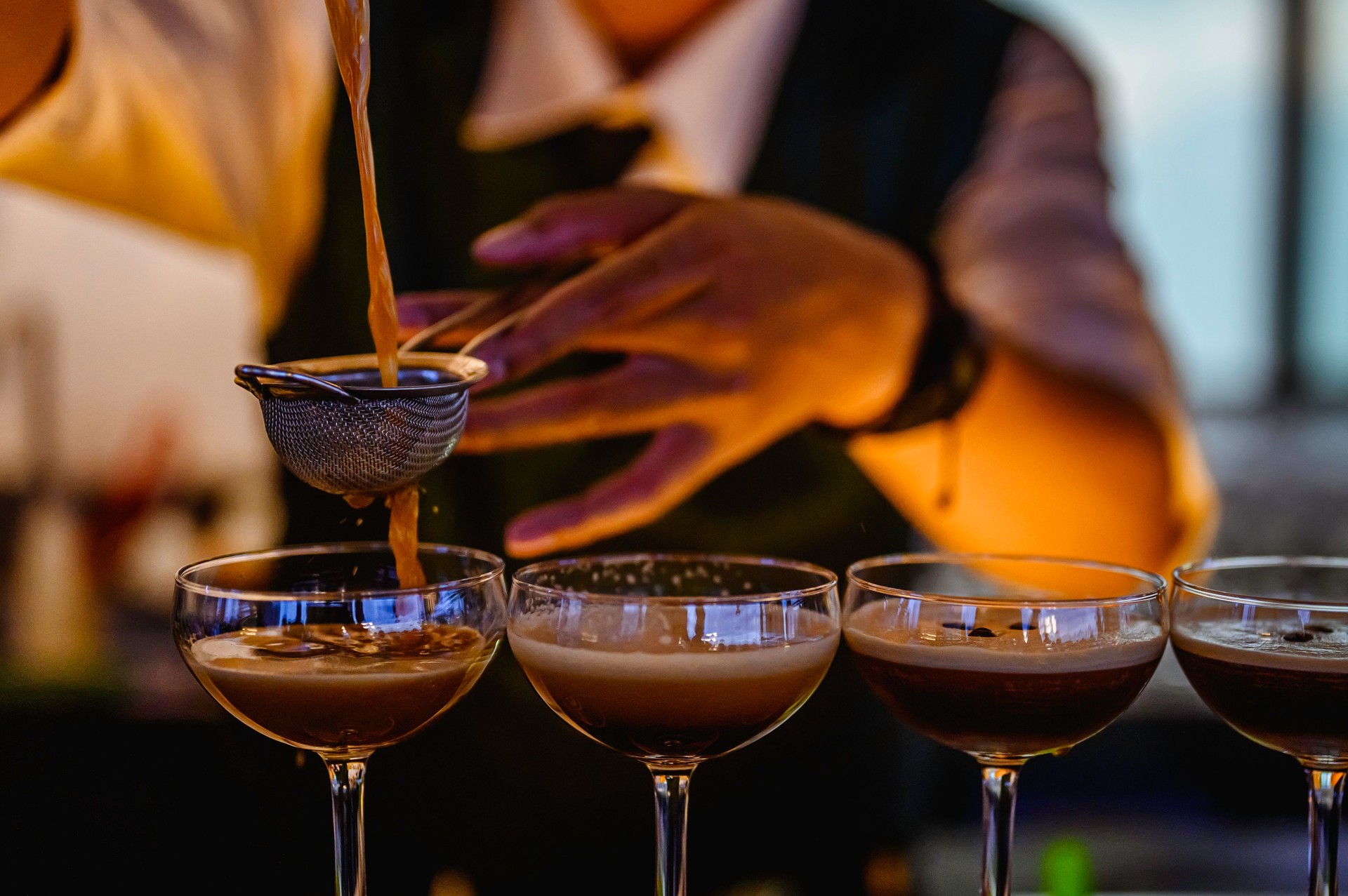 Bartender making alcoholic cocktail at the bar.